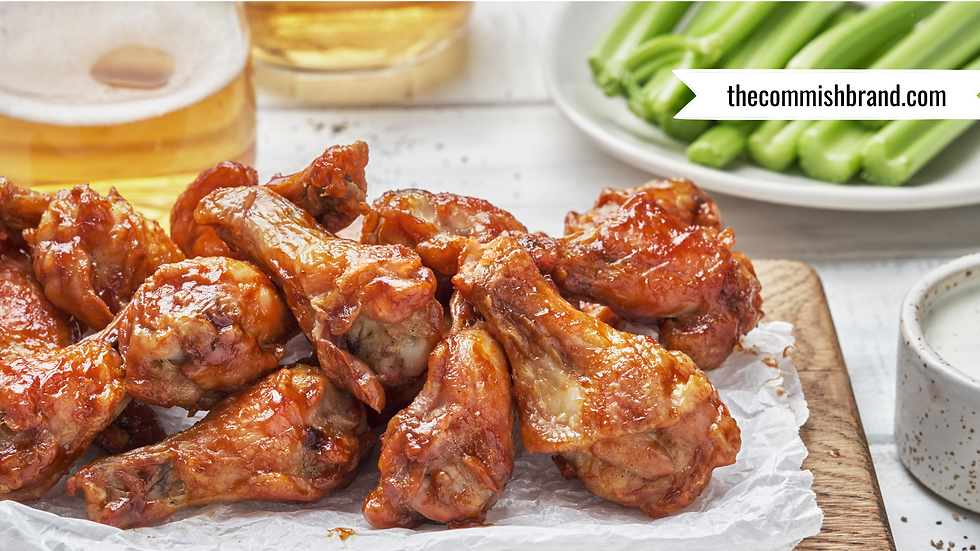 A plate of Buffalo wings and a pint of beer.