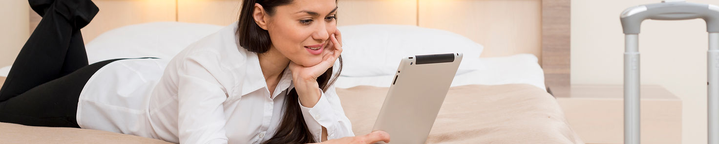 woman-using-tablet-hotel-room.jpg