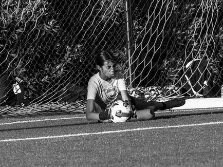Held tight in the keeper's gloves.