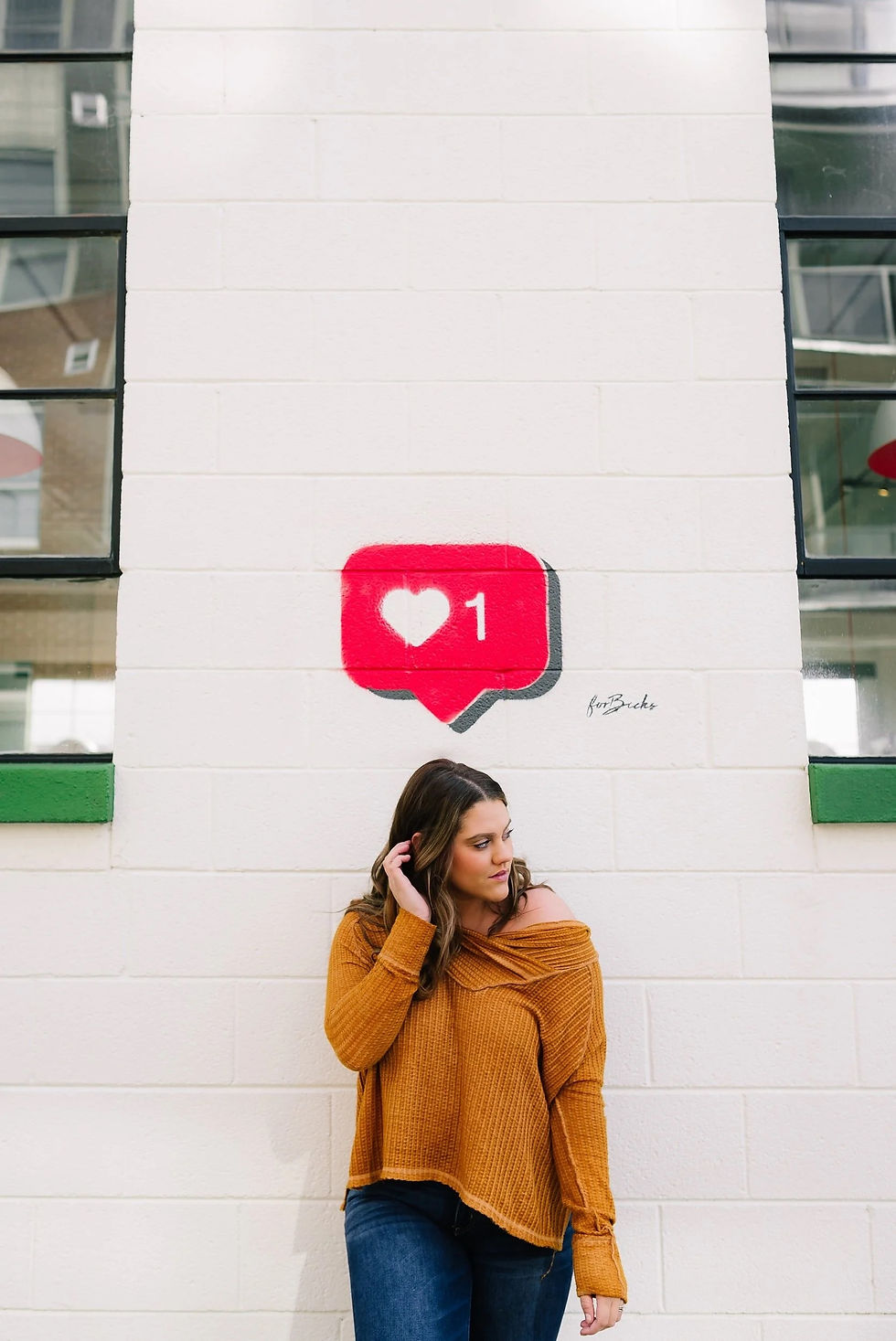 Professional woman standing beneath a social media icon representing nanny social media boundaries and online professionalism in childcare.
