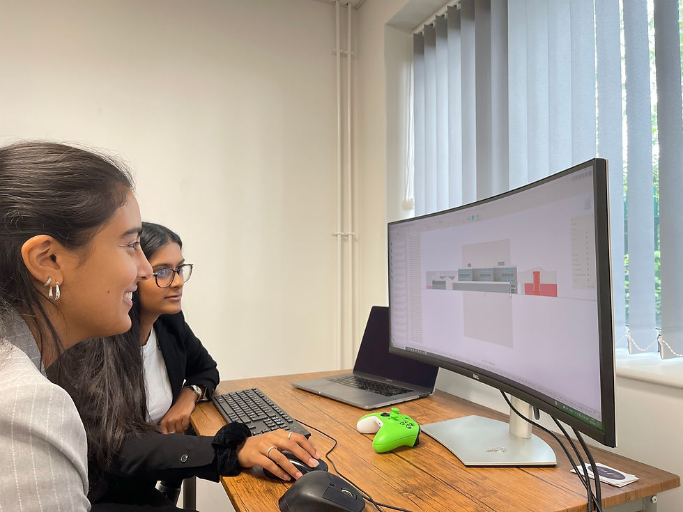 Two graduates are designing a computer aided design model from a point cloud scan to develop a virtual twin of a factory