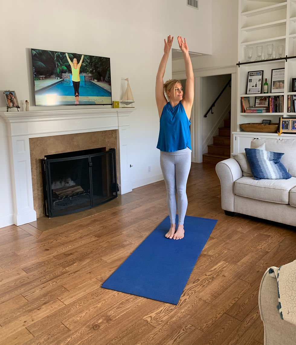 LaReine practicing mindfulness and yoga stretch with the video behind her