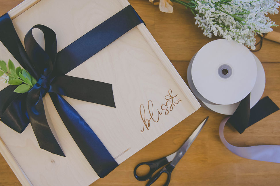 Box with scissors and ribbon on table.jp