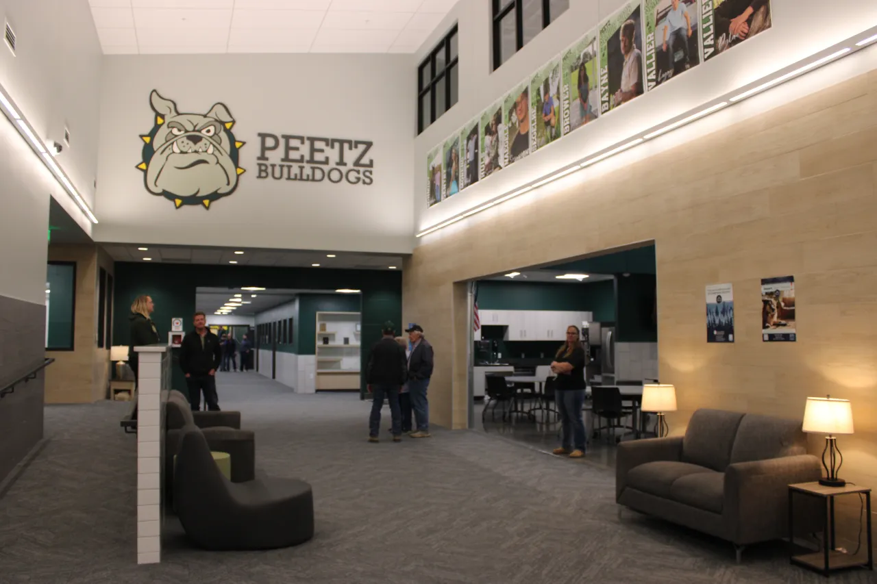 Guests chat in the lobby of the new Peetz School during a grand opening celebration Monday, Jan. 5.