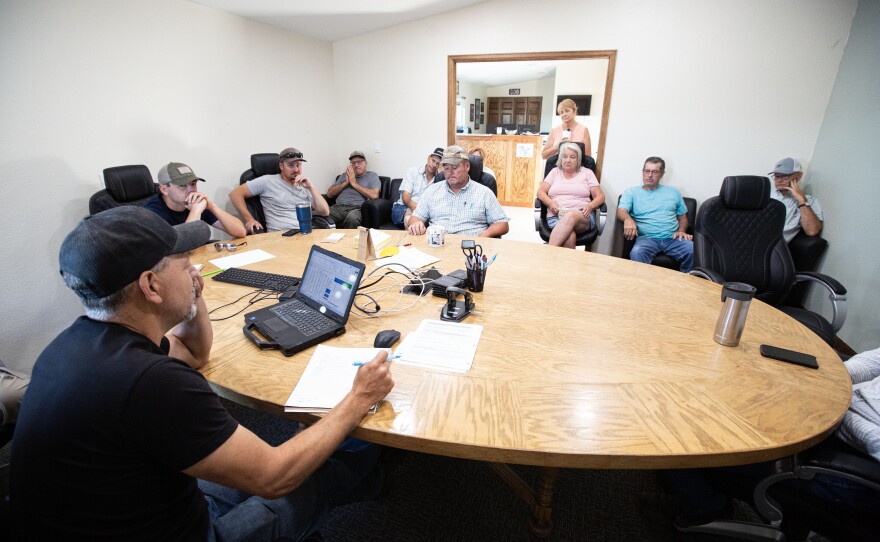 Brothers Rod and George Lenz talk in a work shed on Lenz Farms in Yuma County.