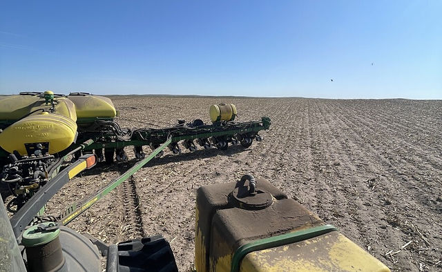A flatbed trailer truck with two tanks holding fertilizer sits on a cornfield on Lenz Farms.
