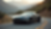 Aston Martin parked on a scenic road, showcasing luxury and performance