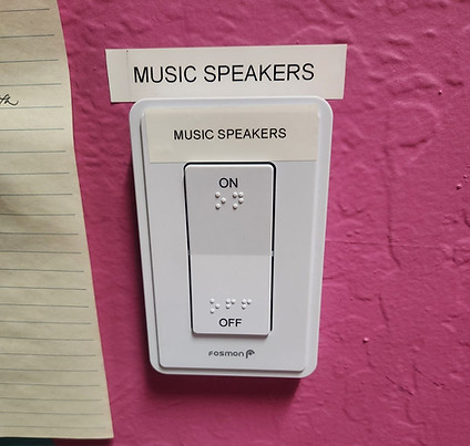 A large white light switch labeled "Music Speakers"