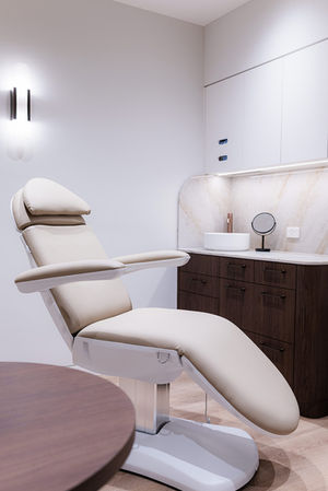 Modern, minimalist medical and laser consulting room.