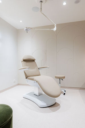 Cosmetic Surgeons consulting room with modern chair and decorative wall panelling.