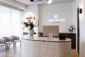 Modern heathcare reception area with elegant signage and neural yet textured materials and finishes palette.