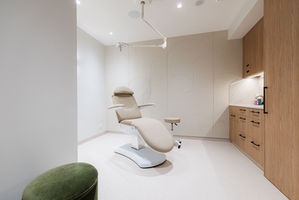 Modern, minimalist medical laser treatment room design.