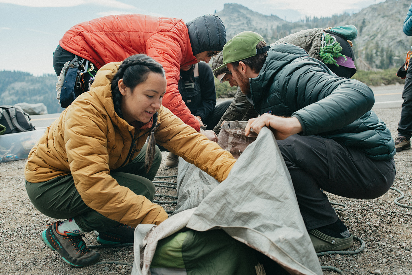 Course participants work together to wrap a simulated patient using equipment available to their team