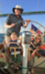 Grandfather and grandkids sailing in newport