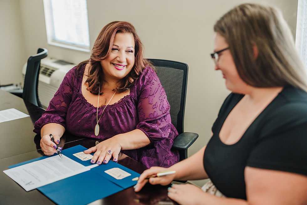 Massachusetts probate attorney Amy Azza smiles with a client while guiding her through the first steps before probate.