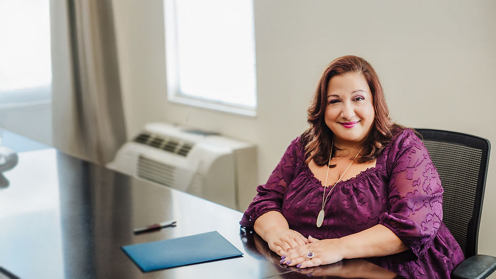 Amy Azza Estate Attorney Sitting at Desk