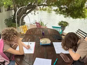 Kinder machen Homeschooling am Wasser