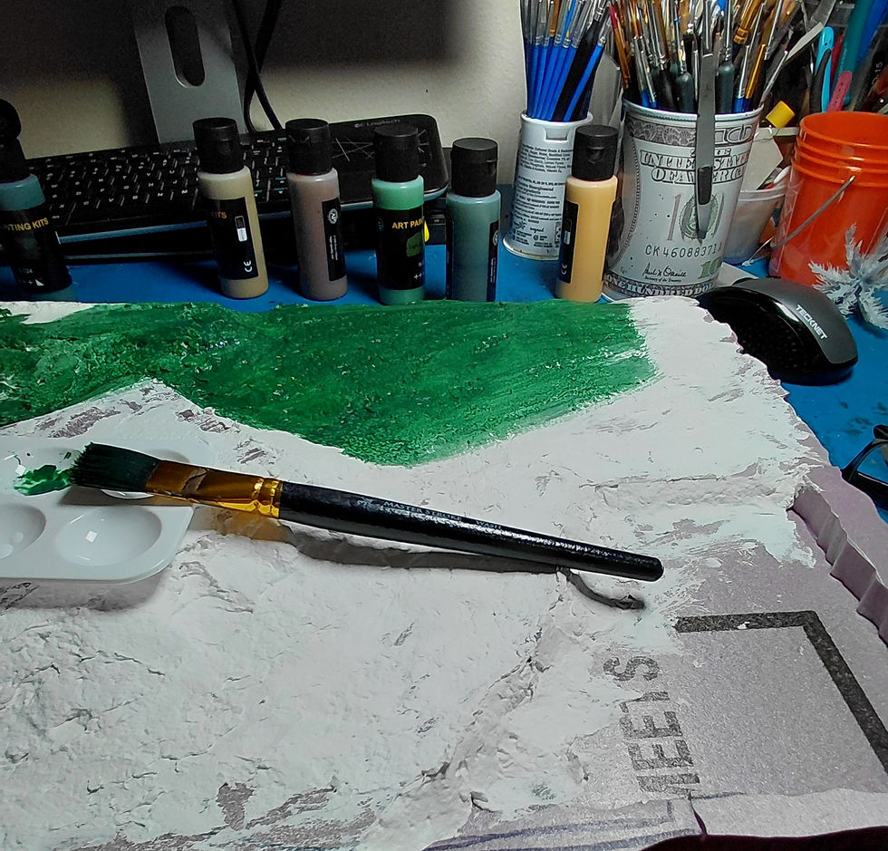 The texturing stage: applying plaster over the foam base and laying down the initial green acrylic undercoat.