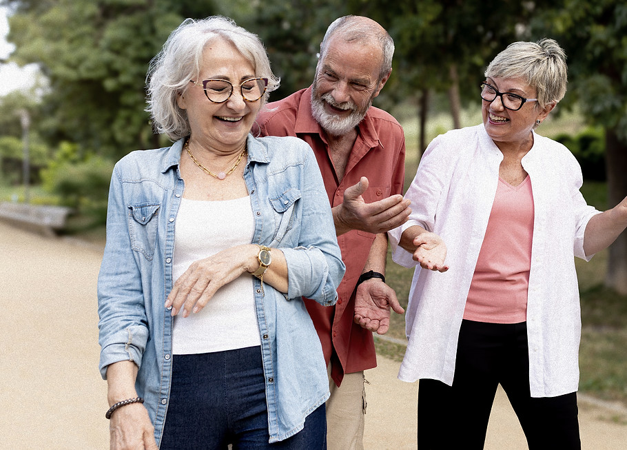 Group of smiling elderly friends walking and talking together outdoors_edited_edited.jpg