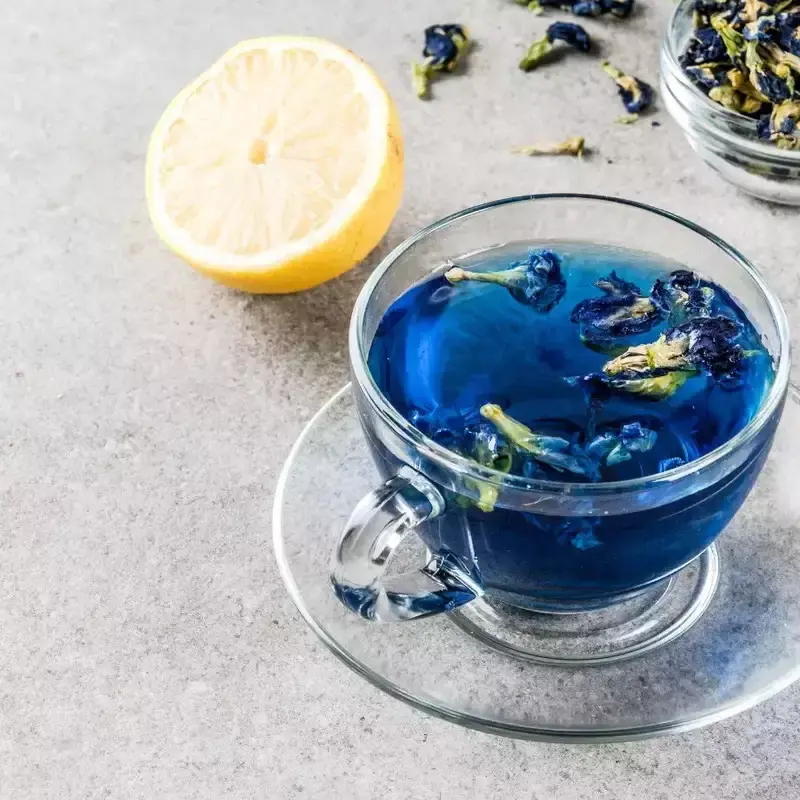 Thumbnail: A cup of Butterfly Pea tea (also known as Blue Pea or Asian Pigeonwing) prepared with a slice of lemon in a glass teacup