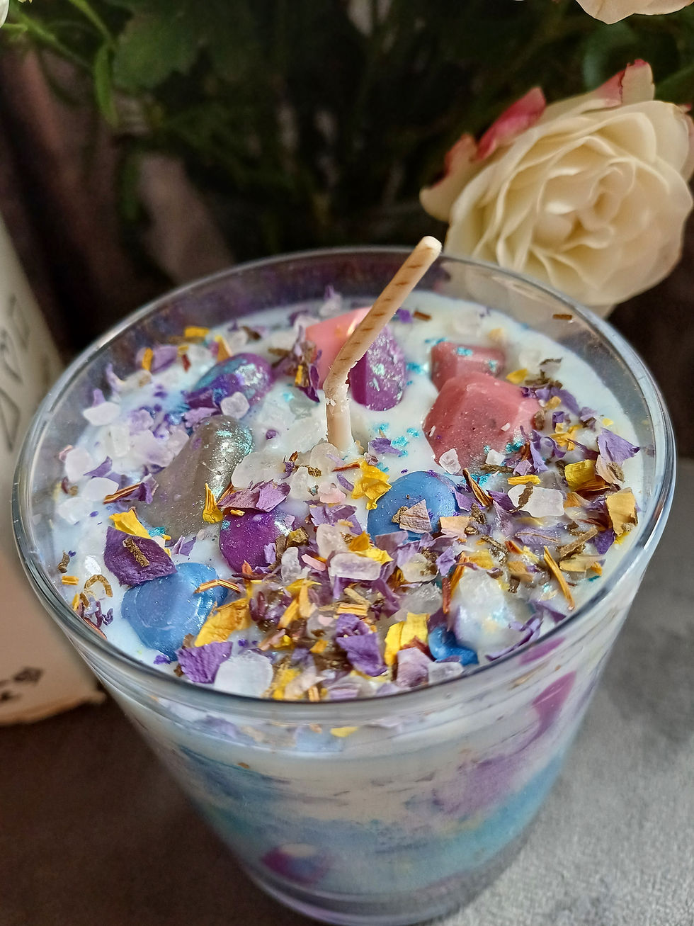 Thumbnail: Top view of embeds in Blue Lotus handmade candle by iAMBeyond Health & Wellbeing, including herbs, crystals and wax gems