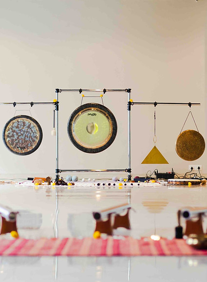 Expert leading a corporate sound healing session using multiple instruments.