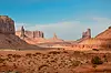 desert scape with large rocky structures in the background