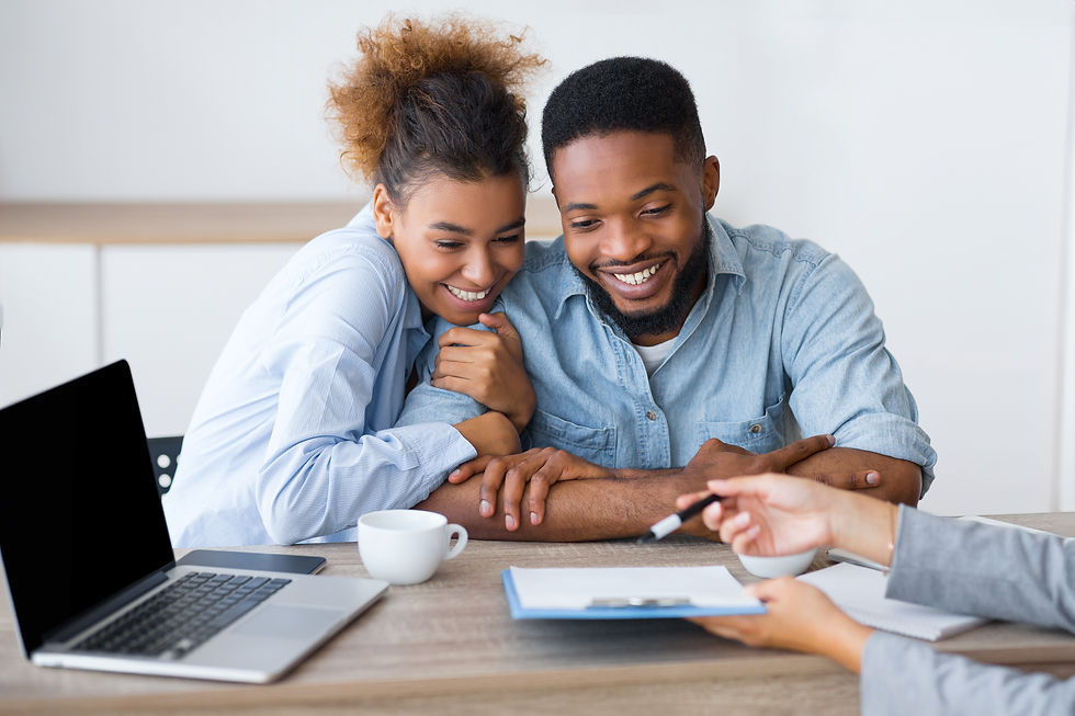 Joyful African American couple sitting with financial counselors, discussing credit repair services, debt solutions, and stra