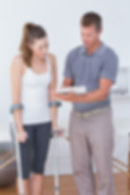 muscle-development-nice-professional-therapist-standing-front-patient-while-holding-his-le