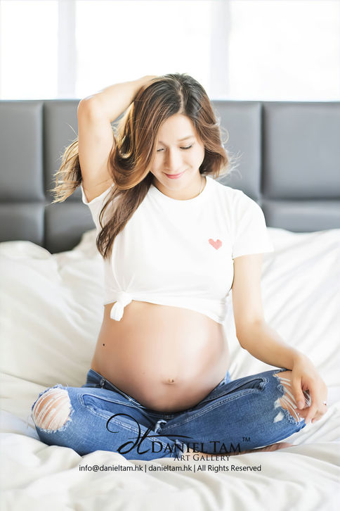 Linda Chung maternity shoot in jean and white t-shirt