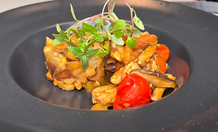 Wild mushrooms with chickpeas, prepared for private dining.