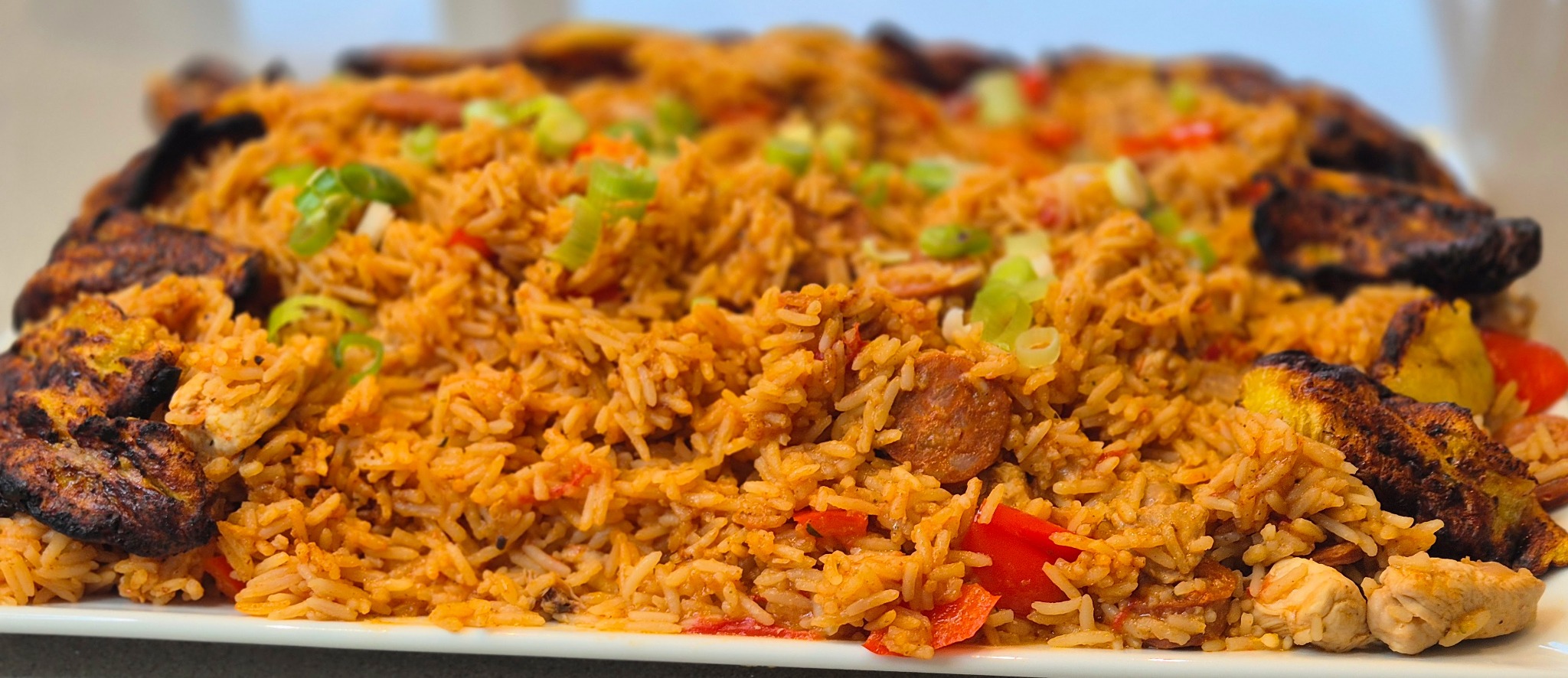 Noba Kitchen jambalaya sharing platter with seasoned rice, peppers and plantain.