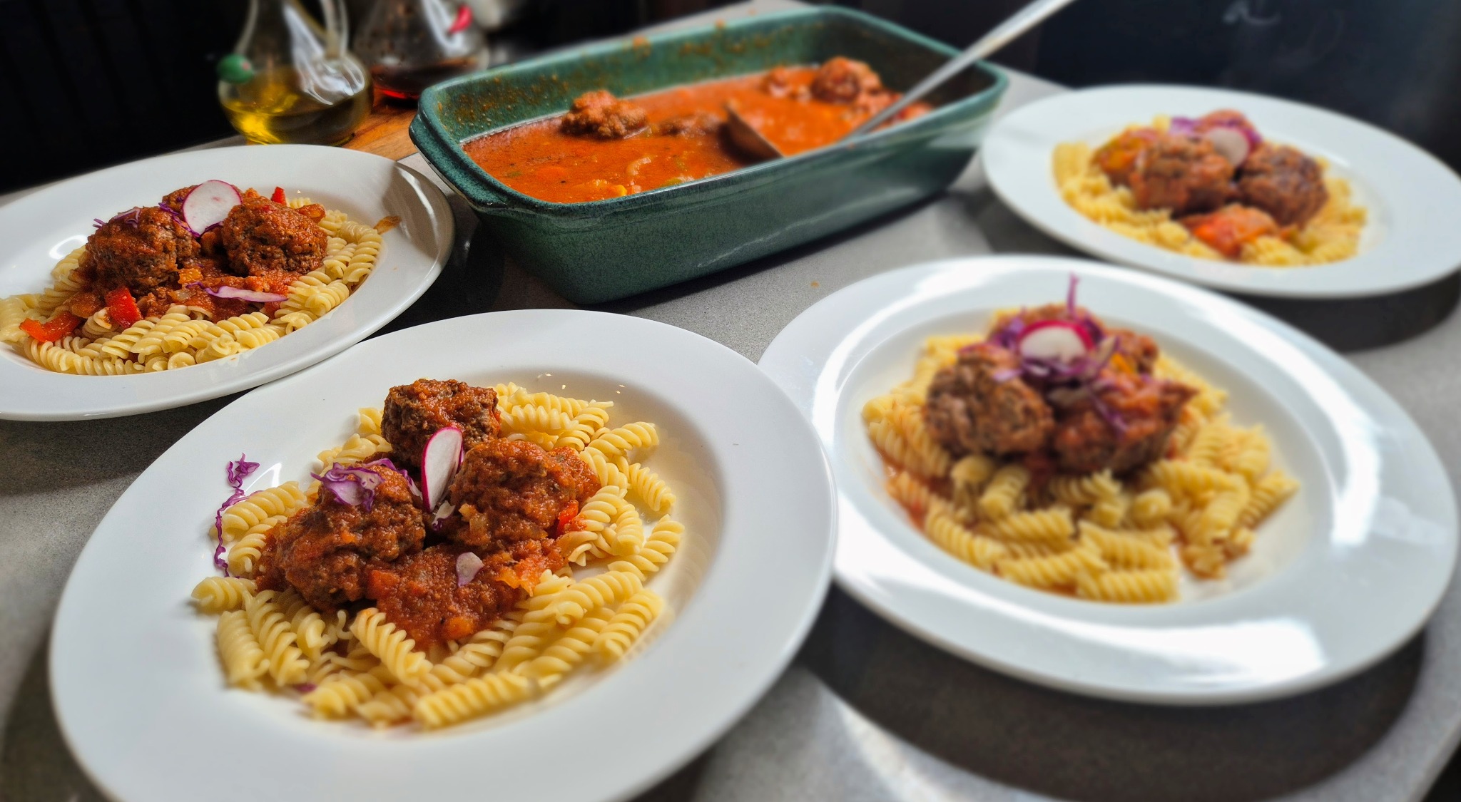 Noba Kitchen beef meatballs with pasta, showing served portions and a sharing dish of meatballs in sauce.