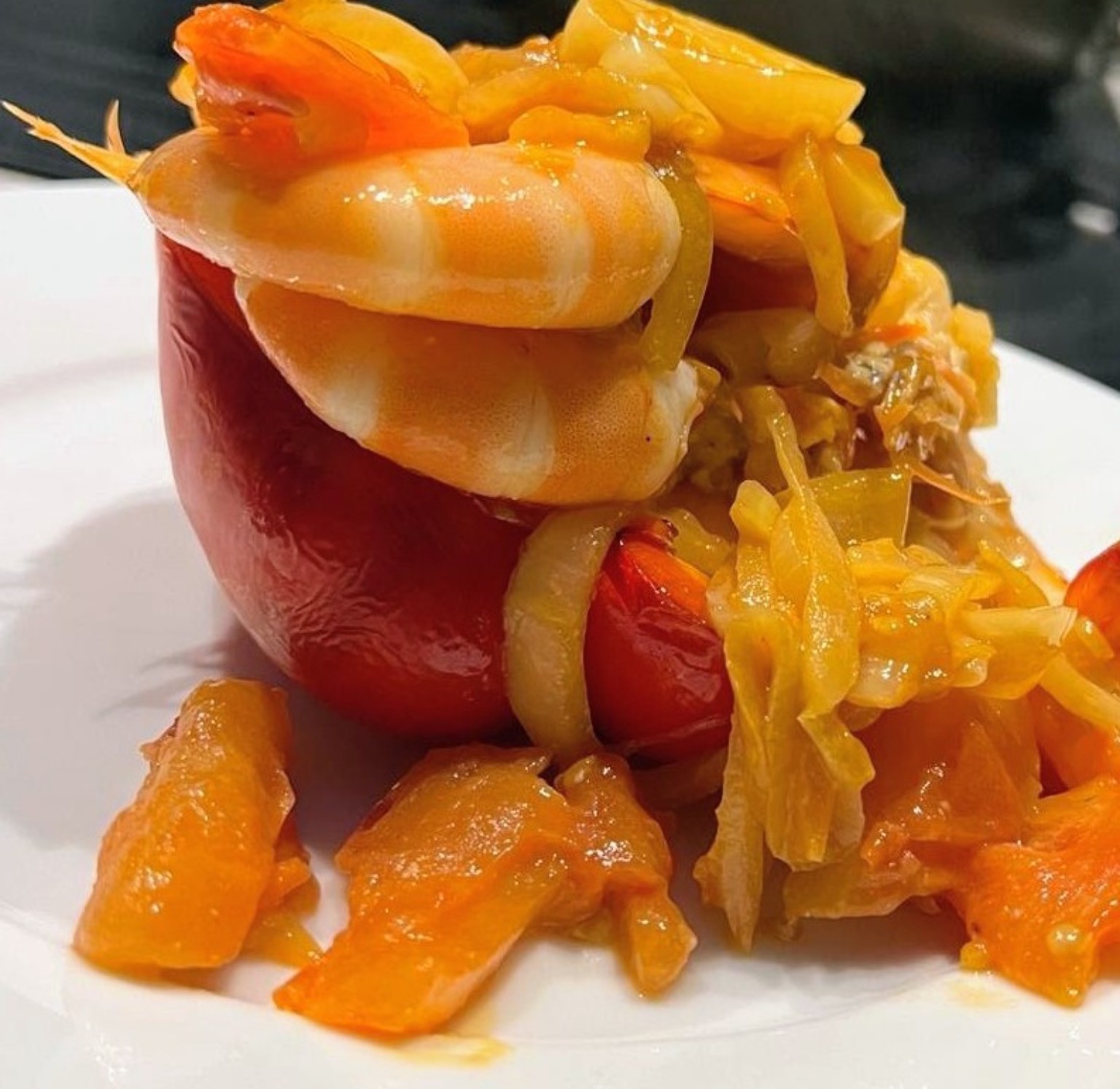 Red pepper filled with tomatoes, onions and large prawns, prepared by Noba Kitchen.