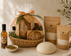 Palm and proof sourdough gift basket with dipping oils, fresh dough, and packaged bakery goods like dehydrated starter and granola