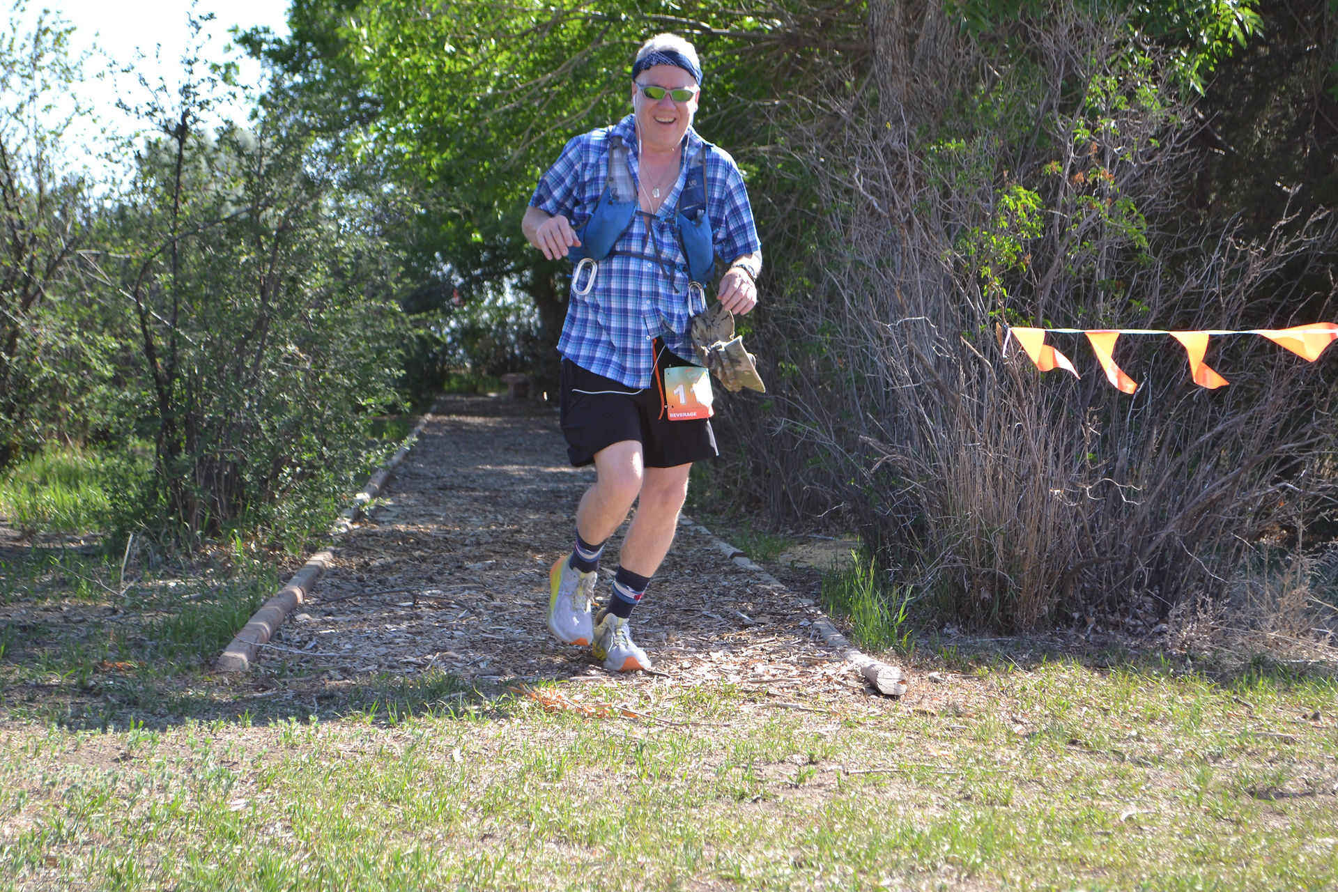 Let's Feel Great Sports | Runner existing a wooded trail section during a running race event