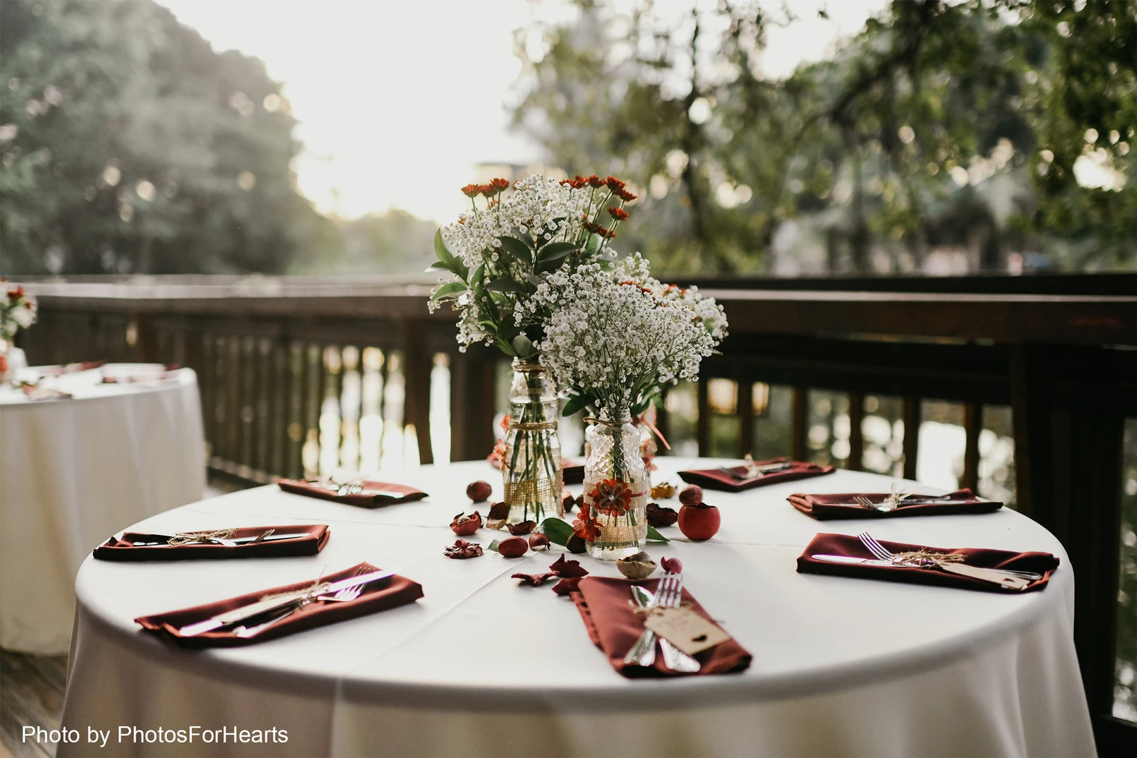 Beautiful dining table set up on a balcony with rich greenery in the background