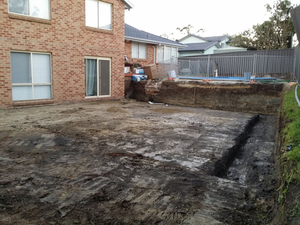 landscaping preparation using excavator on residential property