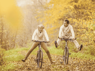 An elderly couple enjoys the outdoors in fall.