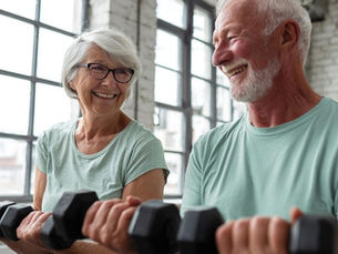 An elderly couple works out together.