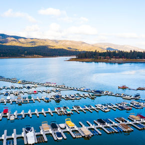 Aerial drone images of the colorful boats and mountain side.