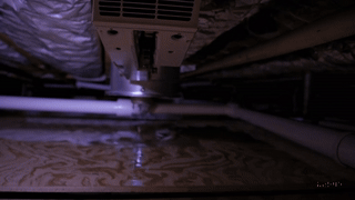 "Inspecting leaking HVAC condensation drain to prevent water damage from air handler.