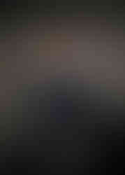 Male graduate in black cap and gown posing for professional studio photo in Hollywood Florida