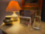 Side table with lamp, holder containing price lists, gift vouchers, loyalty cards & after care advic