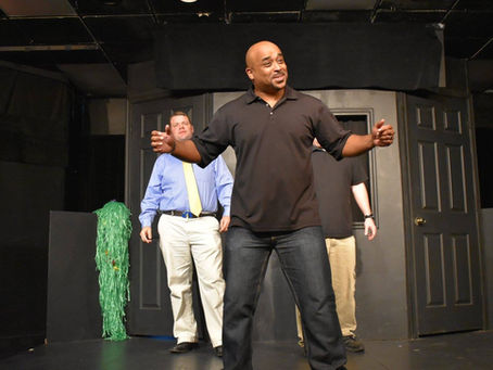 Damon Mitchell performing improv on stage.