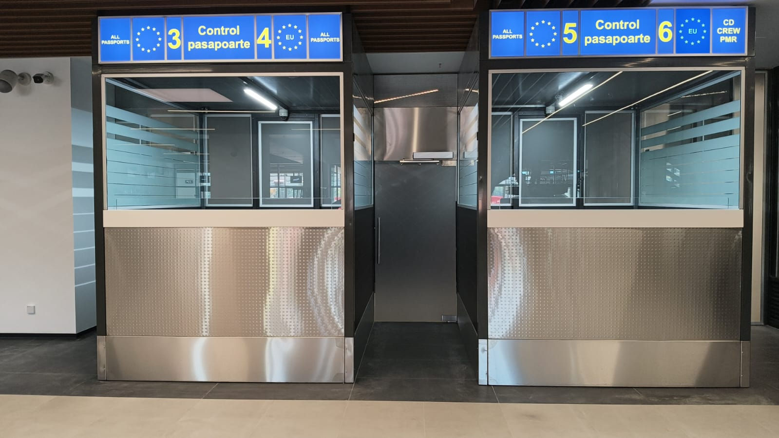 passport control booths installed in an airport immigration area