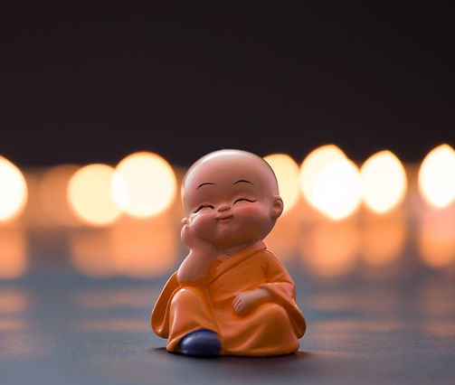 Monk baby is leaning his head on his han