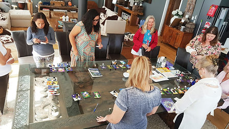 workshop gathering run by Ruth at a retreat showing ladies engaging in the activity of choosing their oils and reading about their metaphysical properties