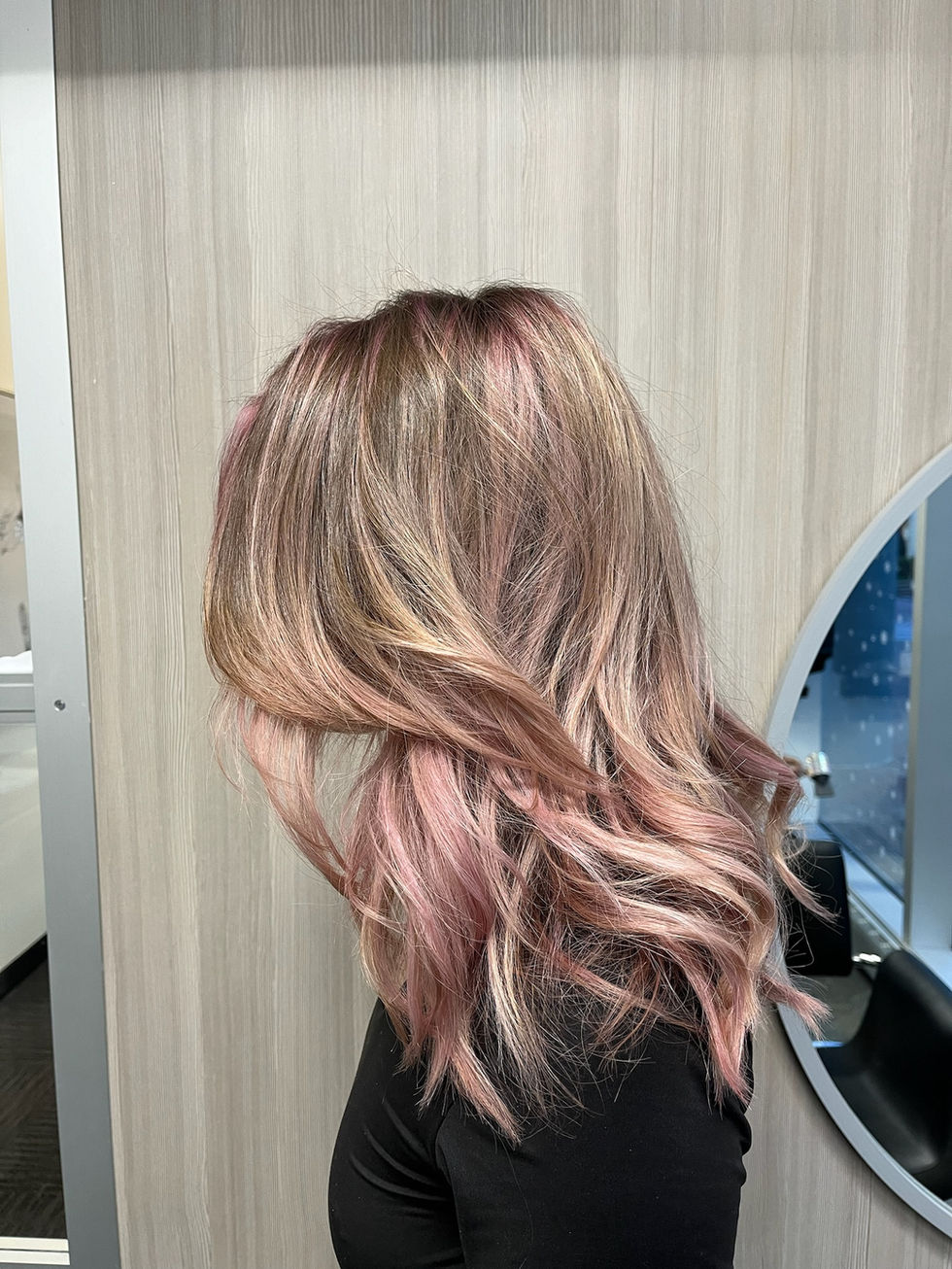 Pink and blonde balayage styled with waves.