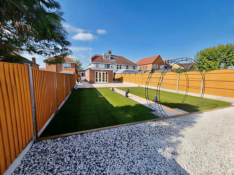 Professionally landscaped garden with patio and lawn